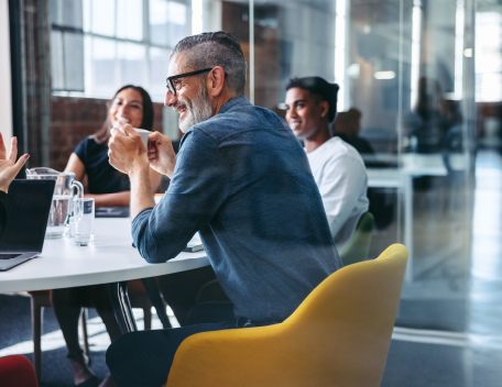 A few people around a table having a meeting